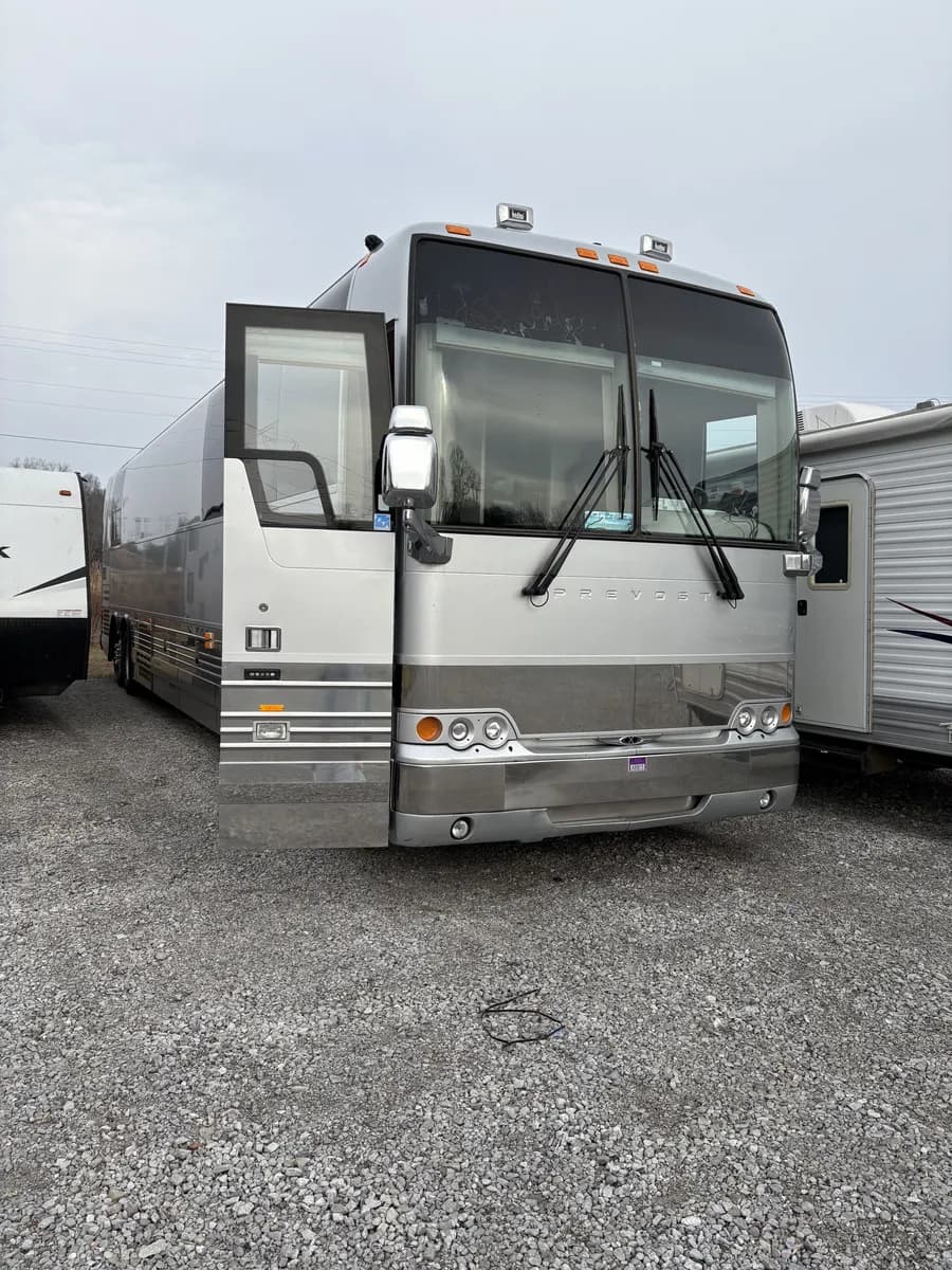 Prevost X3-45 front quarter before refinishing showing paint wear and chips